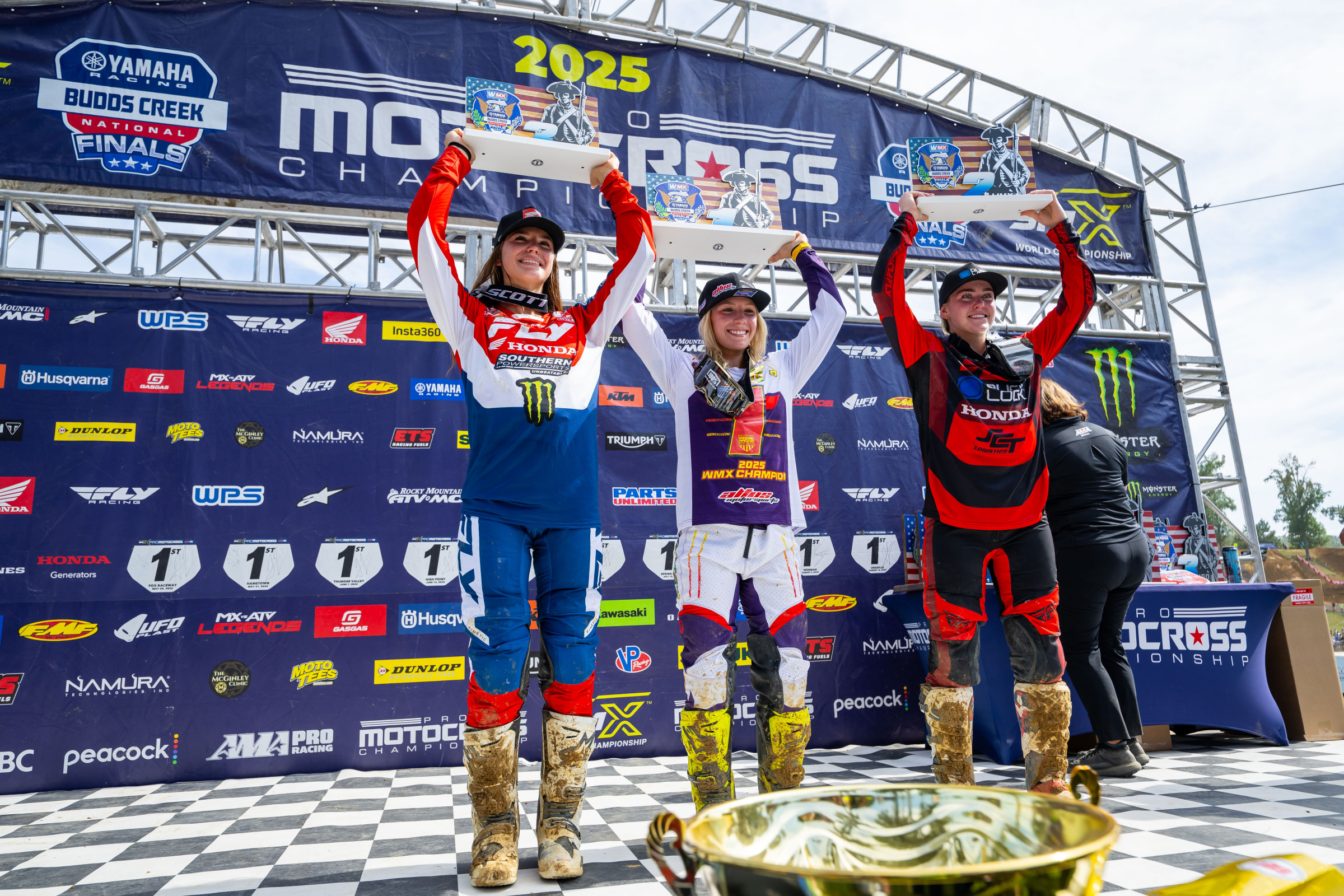 Mikayla Nielsen (left), Lala Turner (center), and Charli Cannon celebrate podium finishes at Budds Creek.