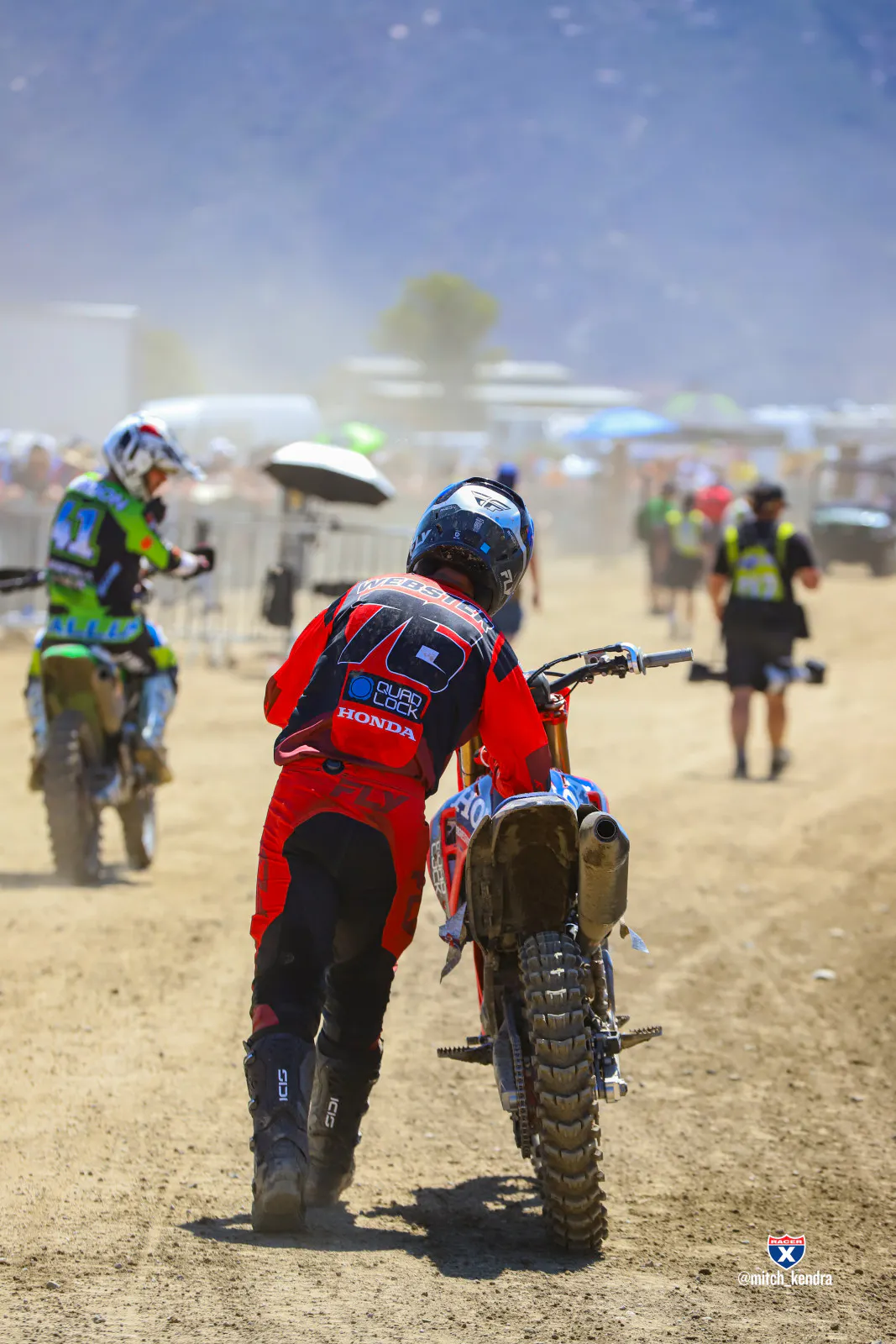 Kyle Webster pushing his bike after it gave out at the end of the first 450 moto.